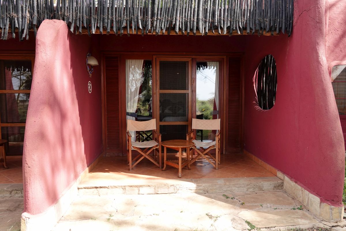 Private Terrasse eines Zimmers der Amboseli Serena Lodge mit Sitzgelegenheiten und traditioneller Safari-Architektur.